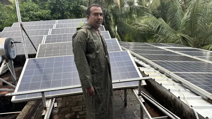 Rooftop solar array being inspected alongside a solar water heater