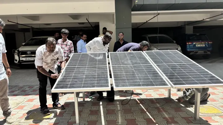 JRS SunTech Energy team installing solar panels on a ground-mounted structure